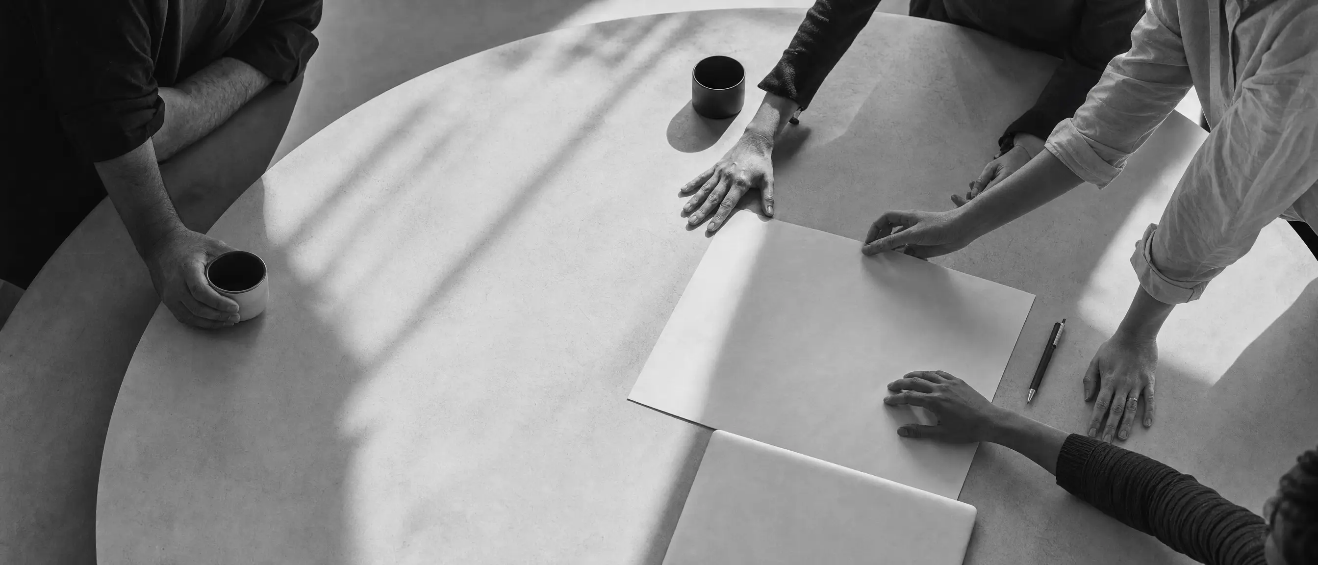 An overhead editorial illustration of collaborators working around a shared table